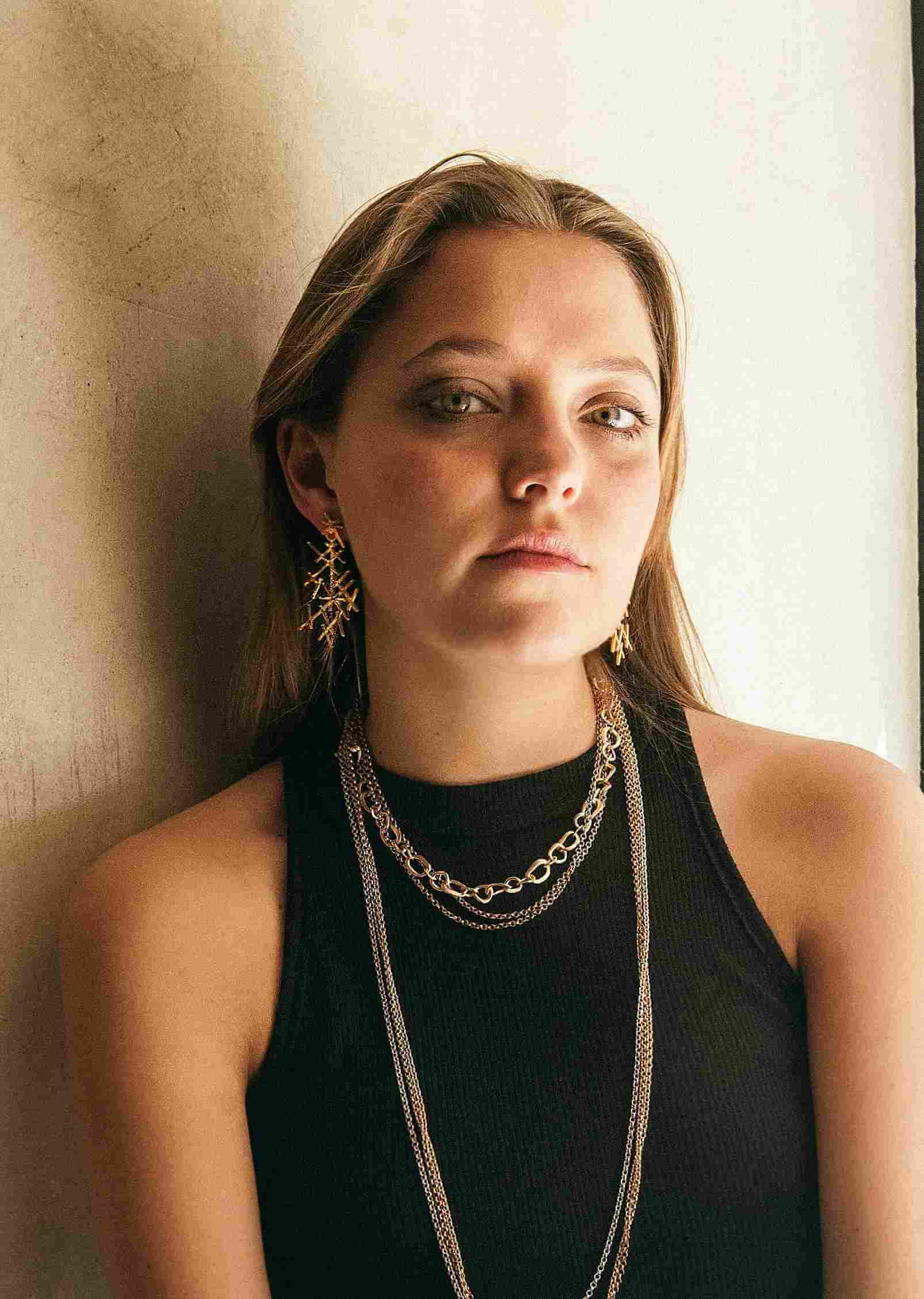 Young woman, wearing earrings and necklace from Karen Eddy